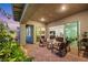Inviting covered patio with brick pavers, seating area, and manicured landscaping at 712 Webber Park St, Henderson, NV 89011