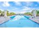 Sparkling swimming pool surrounded by lounge chairs, umbrellas, and well-manicured landscaping for ultimate relaxation at 712 Webber Park St, Henderson, NV 89011