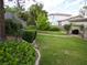 Lush backyard featuring green lawn, landscaped borders, and a charming patio at 7313 Bosky Springs St, Las Vegas, NV 89131