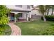 Expansive backyard featuring a stone pathway, covered patio, and mature trees at 7313 Bosky Springs St, Las Vegas, NV 89131