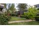 Serene backyard featuring lush greenery, a well-maintained lawn, and a curved walkway at 7313 Bosky Springs St, Las Vegas, NV 89131