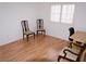 Bright bedroom features wood floors, a window with shutters, and classic chairs at 7313 Bosky Springs St, Las Vegas, NV 89131