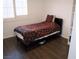 A modern bedroom with wood floors, a window with shutters, and a comfortable bed at 7313 Bosky Springs St, Las Vegas, NV 89131