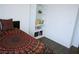 Bedroom view with bookshelf, laminate floor and bed with colorful mandala patterned bedding at 7313 Bosky Springs St, Las Vegas, NV 89131