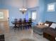 Light and bright dining room with statement chandelier and light blue colored walls at 7313 Bosky Springs St, Las Vegas, NV 89131