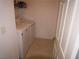 Well-lit laundry room featuring a new washer and dryer combo at 7313 Bosky Springs St, Las Vegas, NV 89131