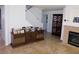 Bright living room featuring staircase, fireplace, and ornate wooden cabinet, with tile flooring at 7313 Bosky Springs St, Las Vegas, NV 89131