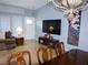 Open-concept living room with entertainment center and views of dining space at 7313 Bosky Springs St, Las Vegas, NV 89131