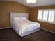 Comfortable main bedroom with a tufted headboard and window with plantation shutters at 7313 Bosky Springs St, Las Vegas, NV 89131