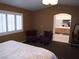 Spacious main bedroom featuring plantation shutters, sitting area, and ensuite bathroom at 7313 Bosky Springs St, Las Vegas, NV 89131