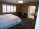 Spacious main bedroom featuring plantation shutters, sitting area, and ensuite bathroom at 7313 Bosky Springs St, Las Vegas, NV 89131