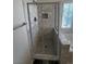 Stylish shower with grey subway tiles and river rock flooring inside a glass enclosure at 7313 Bosky Springs St, Las Vegas, NV 89131