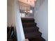 Carpeted staircase leads up to the second floor with white railings and a decorative chandelier visible at 7313 Bosky Springs St, Las Vegas, NV 89131