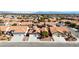 A neighborhood featuring homes with tile roofs, desert landscaping, and solar panels, with mountain views in the background at 7404 Dry Corral Ln, Las Vegas, NV 89113