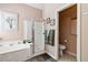 Bathroom featuring a bathtub and a separate glass-enclosed shower, adjacent to the toilet room at 7404 Dry Corral Ln, Las Vegas, NV 89113