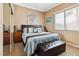 Bedroom with a well-lit window, a comfortable queen bed, and two nightstands at 7404 Dry Corral Ln, Las Vegas, NV 89113