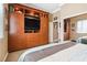Bedroom features an entertainment center with a TV and plenty of storage space at 7404 Dry Corral Ln, Las Vegas, NV 89113