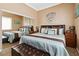 Bedroom with a well-lit window, a comfortable queen bed, and two nightstands with a mirrored closet at 7404 Dry Corral Ln, Las Vegas, NV 89113