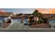Charming single-story home with a two-car garage, desert landscaping, and solar panels at 7404 Dry Corral Ln, Las Vegas, NV 89113