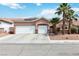 Charming single-story home with a three-car garage and desert landscaping with palm trees at 7404 Dry Corral Ln, Las Vegas, NV 89113
