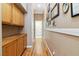 Hallway with wood floors, built-in cabinets, and wall decor, creating a warm and inviting path at 7404 Dry Corral Ln, Las Vegas, NV 89113