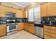 Cozy kitchen featuring stainless steel appliances and tile backsplash at 7404 Dry Corral Ln, Las Vegas, NV 89113