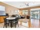 Living room with a ceiling fan, hardwood floors, and a sectional sofa overlooking a backyard pool at 7404 Dry Corral Ln, Las Vegas, NV 89113