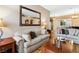 Inviting living room featuring cozy sofas, stylish decor, and a large decorative mirror at 7404 Dry Corral Ln, Las Vegas, NV 89113