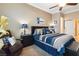 Main bedroom complete with a ceiling fan, an end table, and an upholstered chair at 7404 Dry Corral Ln, Las Vegas, NV 89113