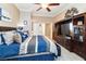 Main bedroom featuring a bed, a ceiling fan and a media center, creating an enjoyable living space at 7404 Dry Corral Ln, Las Vegas, NV 89113