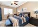Main bedroom with a plush bed, stylish furnishings, and natural light, creating a relaxing retreat at 7404 Dry Corral Ln, Las Vegas, NV 89113