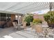 Outdoor patio with pergola cover, seating, and barbecue grill for outdoor living and entertaining at 7404 Dry Corral Ln, Las Vegas, NV 89113