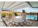 Outdoor patio with pergola cover and pool view, perfect for relaxing at 7404 Dry Corral Ln, Las Vegas, NV 89113