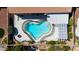 Aerial view of a heart-shaped pool with built in steps and a surrounding patio and desert landscaping at 7404 Dry Corral Ln, Las Vegas, NV 89113