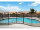 Backyard swimming pool surrounded by a safety fence, providing a secure outdoor space for recreation and relaxation at 7404 Dry Corral Ln, Las Vegas, NV 89113
