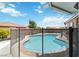 View of a backyard pool with safety fence, perfect for outdoor relaxation and recreation at 7404 Dry Corral Ln, Las Vegas, NV 89113