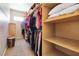 Spacious walk-in closet with shelves, clothing racks, and carpeted floor at 7404 Dry Corral Ln, Las Vegas, NV 89113
