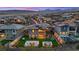 Aerial view of backyard featuring a fire pit, hot tub, outdoor dining area, pool, and mountain views at 754 Spirit Lake St, Las Vegas, NV 89138