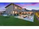 Enjoy the backyard with a fire pit and ample seating on the lush lawn, perfect for relaxing evenings at 754 Spirit Lake St, Las Vegas, NV 89138