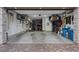 Spacious garage with ample storage, shelving, and an extension into a workout room at 754 Spirit Lake St, Las Vegas, NV 89138