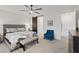 Bright bedroom featuring a decorative bed, accent chair, and a barn door entry to the bathroom at 754 Spirit Lake St, Las Vegas, NV 89138