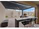 Inviting outdoor kitchen with built-in grill, bar seating, and a covered patio area for entertaining at 754 Spirit Lake St, Las Vegas, NV 89138