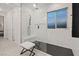 Elegant glass shower featuring marble style tiling, dual shower heads, and a built in storage nook at 754 Spirit Lake St, Las Vegas, NV 89138