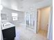 Bright bathroom featuring double sinks, a soaking tub, and a glass-enclosed shower at 756 Sleeping City Ave, Henderson, NV 89015