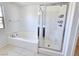 Modern bathroom featuring a soaking tub and a glass-enclosed shower with built-in shelving at 756 Sleeping City Ave, Henderson, NV 89015