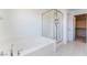 Modern bathroom featuring a soaking tub and a glass-enclosed shower at 756 Sleeping City Ave, Henderson, NV 89015