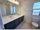 A bathroom with double sinks, a large mirror, and a view of the exterior at 756 Sleeping City Ave, Henderson, NV 89015