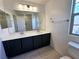 Bathroom featuring a double sink vanity with a large mirror and tiled flooring at 756 Sleeping City Ave, Henderson, NV 89015