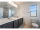 Bright bathroom features a dual sink vanity with modern fixtures and large mirror at 756 Sleeping City Ave, Henderson, NV 89015
