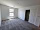 A carpeted bedroom with a window and a closet featuring bi-fold doors at 756 Sleeping City Ave, Henderson, NV 89015